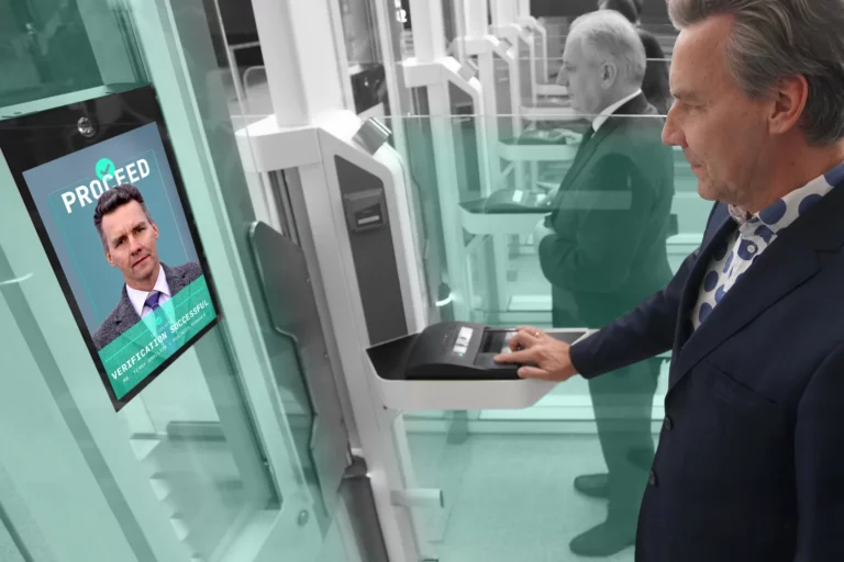 Traveller verifies his identity through biometric door kiosk at airport.